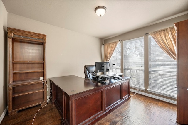 office with dark wood-type flooring and baseboards