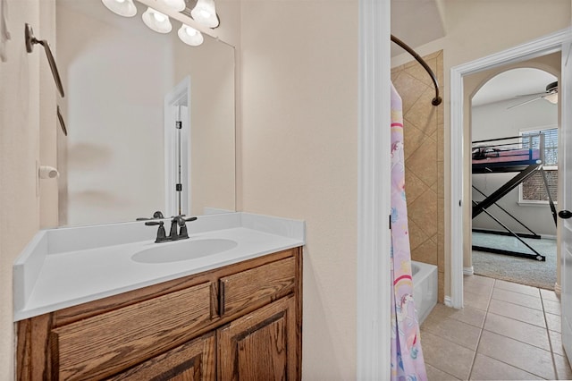 full bathroom featuring tile patterned floors, vanity, shower / bath combo with shower curtain, and a ceiling fan