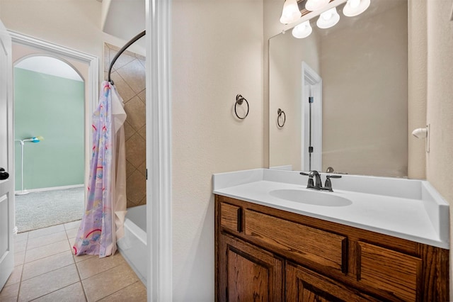 bathroom with tile patterned floors, shower / bathtub combination with curtain, and vanity