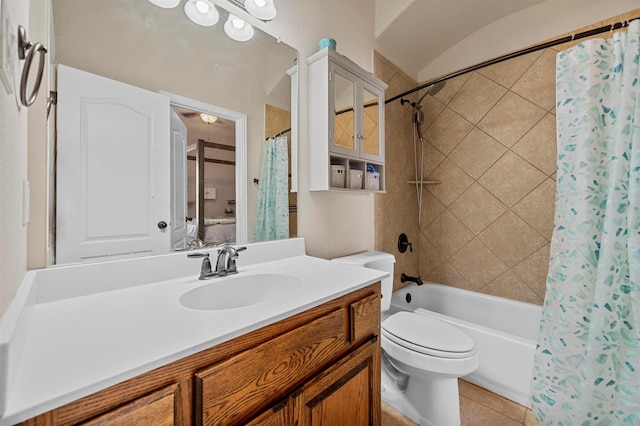 bathroom featuring vanity, toilet, shower / tub combo, and tile patterned flooring