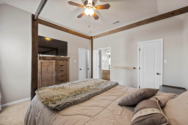 bedroom featuring visible vents, carpet, baseboards, lofted ceiling, and ensuite bath