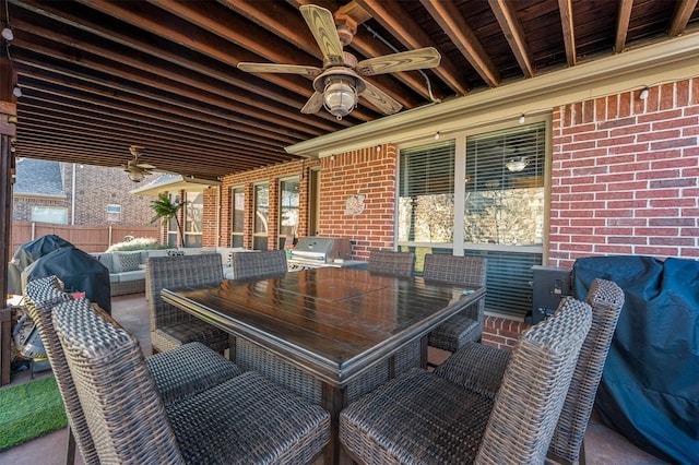 view of patio with ceiling fan, an outdoor hangout area, fence, and grilling area