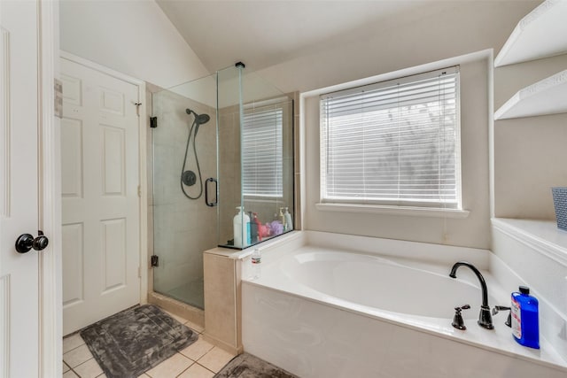 full bath with tile patterned flooring, a shower stall, a garden tub, and vaulted ceiling