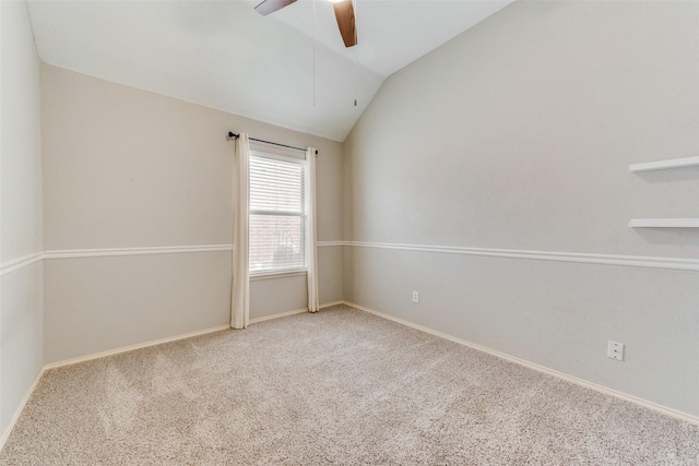 carpeted empty room with baseboards, lofted ceiling, and a ceiling fan