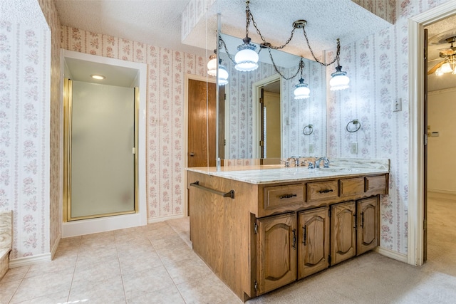 bathroom featuring tile patterned floors, baseboards, a textured ceiling, and wallpapered walls