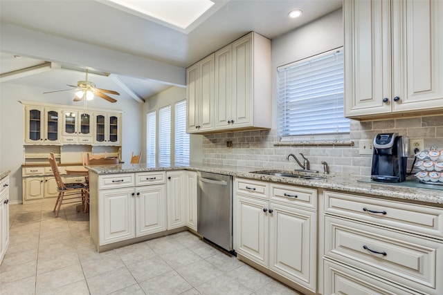 kitchen with backsplash, lofted ceiling with beams, a peninsula, stainless steel dishwasher, and a sink