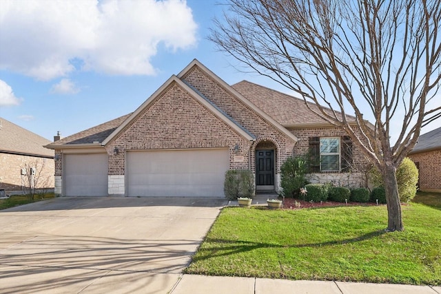 view of front of home with brick siding, a front lawn, concrete driveway, roof with shingles, and an attached garage