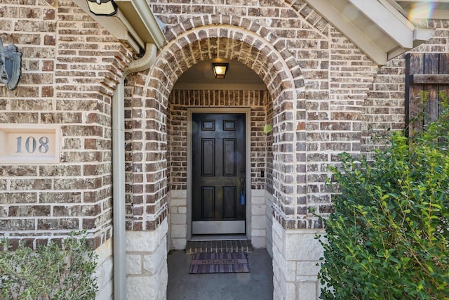 entrance to property with brick siding and stone siding