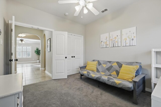 108 Zion Ln, Forney, TX 75126 - carpeted living room featuring ceiling fan, arched walkways, baseboards, and tile patterned flooring