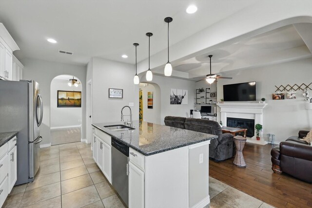 108 Zion Ln, Forney, TX 75126 - kitchen featuring a sink, arched walkways, appliances with stainless steel finishes, ceiling fan, and open floor plan