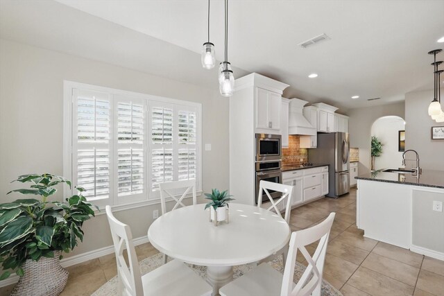 108 Zion Ln, Forney, TX 75126 - spare room with a ceiling fan, arched walkways, hardwood / wood-style flooring, and baseboards