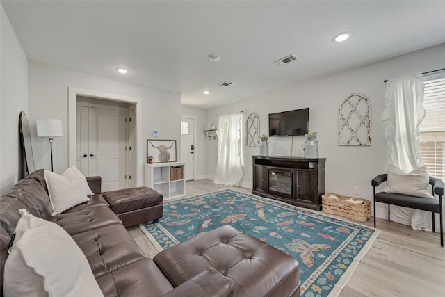 1403 Franklin Ave, Bonham, TX 75418 - living area featuring wood finished floors, recessed lighting, and a glass covered fireplace