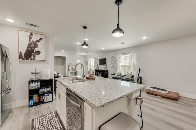 1403 Franklin Ave, Bonham, TX 75418 - kitchen with a sink, appliances with stainless steel finishes, light wood finished floors, baseboards, and recessed lighting