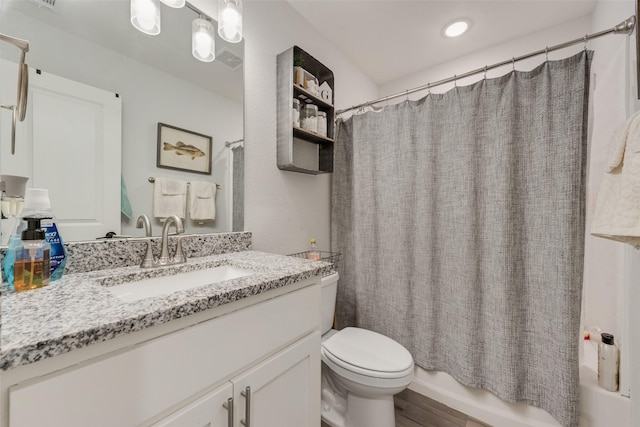 1403 Franklin Ave, Bonham, TX 75418 - full bathroom with vanity, toilet, shower / bath combo with shower curtain, and wood finished floors