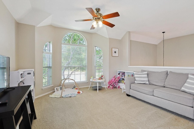 interior space featuring baseboards, a ceiling fan, lofted ceiling, and carpet floors