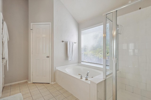 bathroom featuring a bath, a shower stall, tile patterned floors, and baseboards