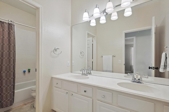 bathroom featuring double vanity, toilet, shower / tub combo with curtain, and a sink