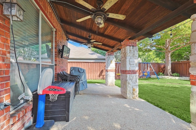 view of patio / terrace with a playground, a fenced backyard, and ceiling fan