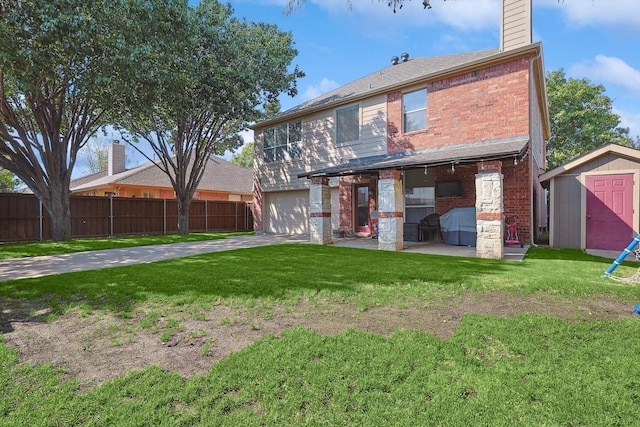 rear view of property with fence, a shed, a yard, a chimney, and an outdoor structure