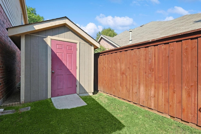 view of shed featuring fence