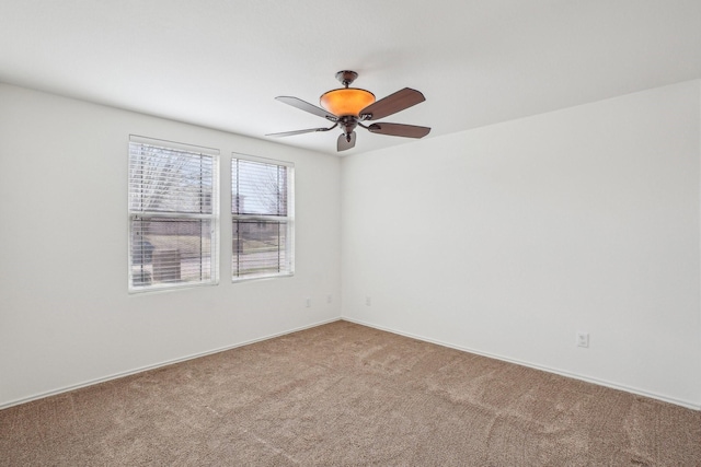 spare room with ceiling fan and light carpet