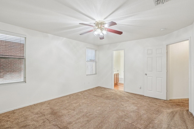 empty room with light colored carpet and ceiling fan