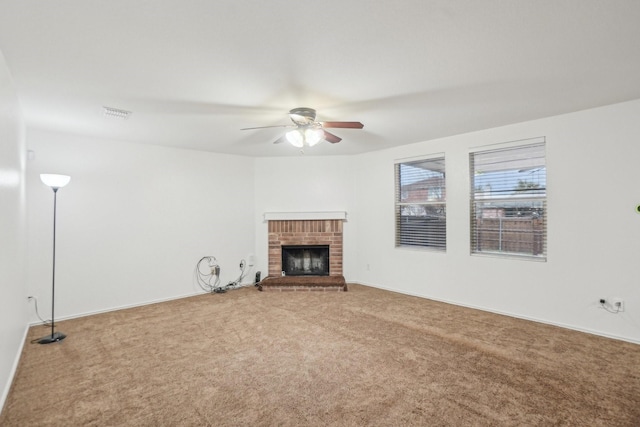 unfurnished living room featuring baseboards, carpet, ceiling fan, and a fireplace