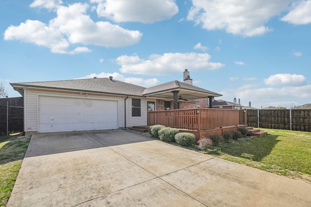 view of front of property featuring fence, driveway, a chimney, a front lawn, and a garage