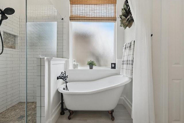 bathroom with a soaking tub and a walk in shower