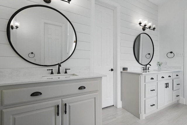 bathroom featuring two vanities and a sink