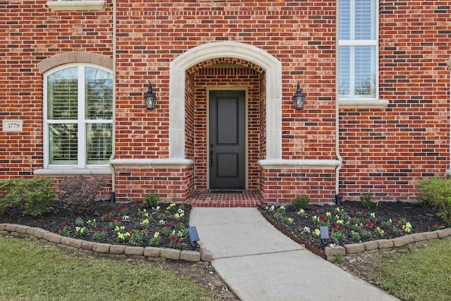 property entrance featuring brick siding