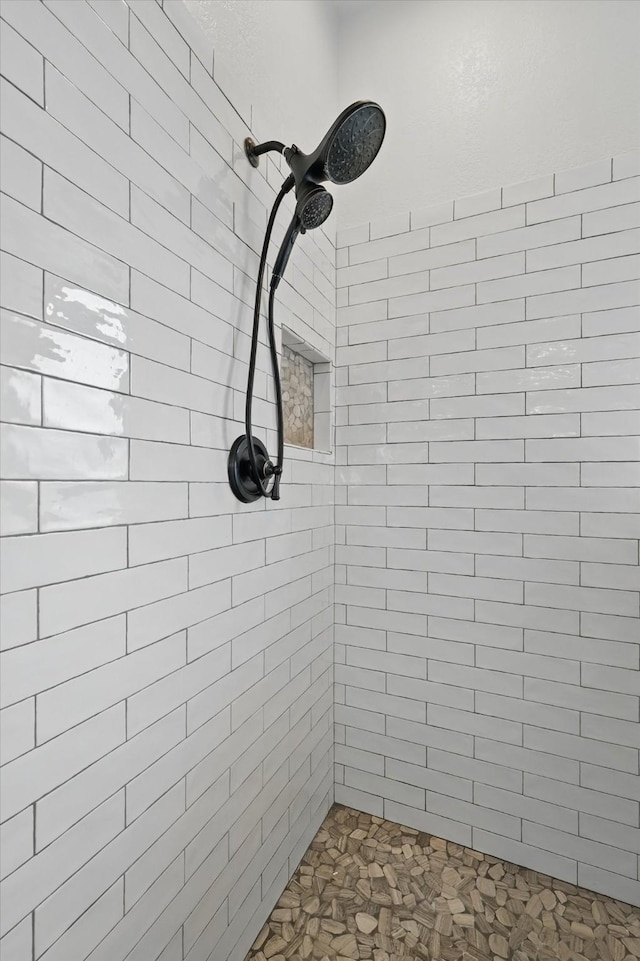 bathroom with tiled shower