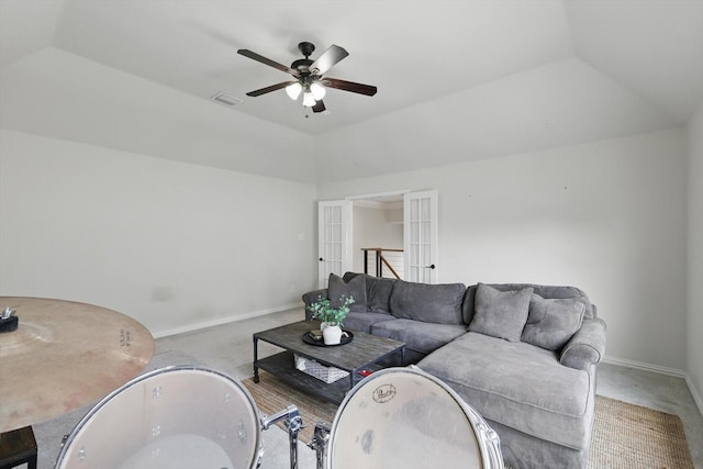 carpeted living area with visible vents, lofted ceiling, baseboards, and a ceiling fan