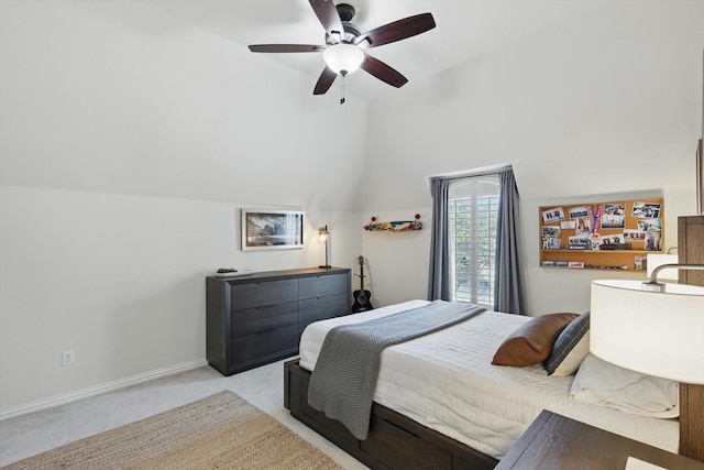 bedroom featuring light colored carpet, baseboards, lofted ceiling, and a ceiling fan