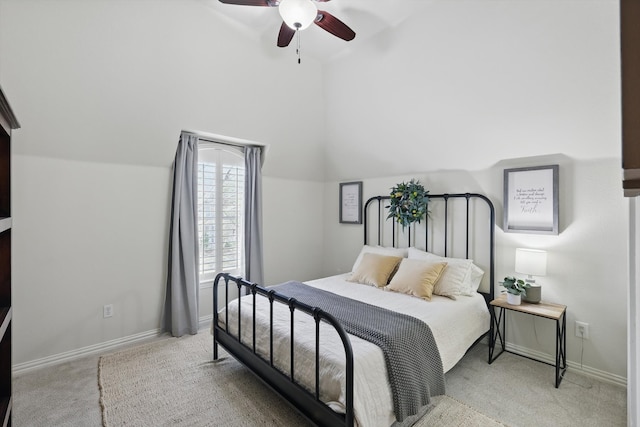 bedroom featuring lofted ceiling, light colored carpet, baseboards, and ceiling fan