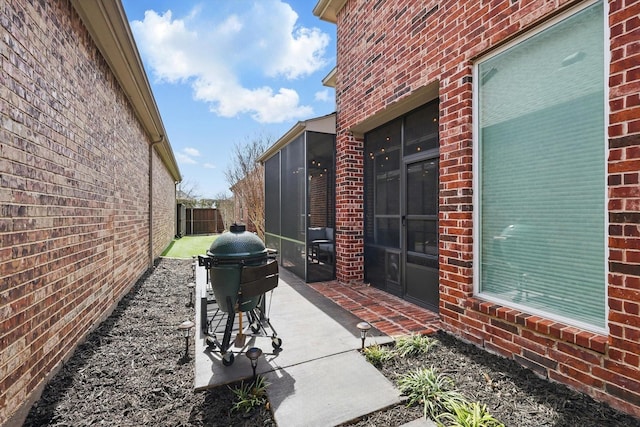 view of patio / terrace featuring a grill and fence