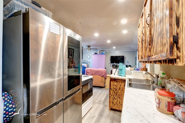 kitchen featuring smart refrigerator, a sink, open floor plan, white electric range oven, and ceiling fan