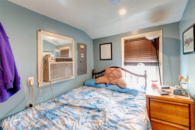 bedroom with electric panel, cooling unit, and vaulted ceiling