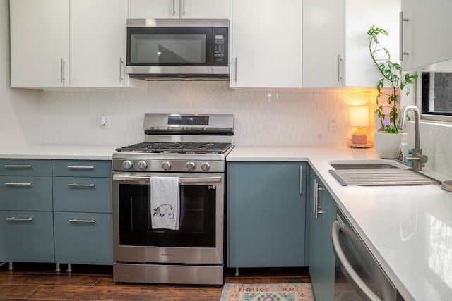 kitchen with a sink, light countertops, tasteful backsplash, and stainless steel appliances