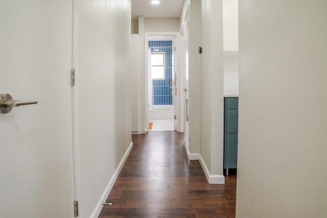 corridor featuring recessed lighting, baseboards, and dark wood finished floors