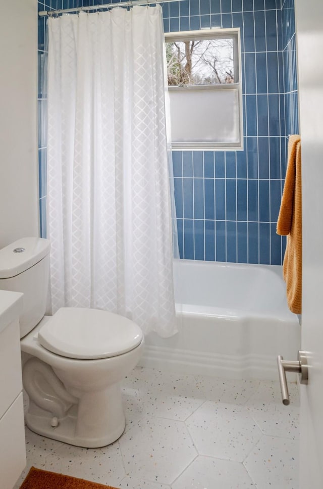 full bath featuring tile patterned floors, toilet, and shower / tub combo with curtain