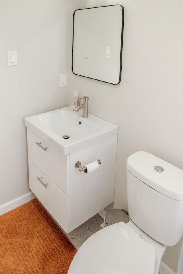 half bathroom with vanity and toilet