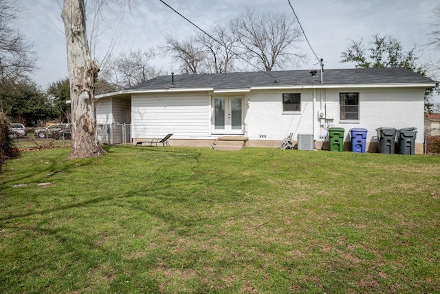 back of house featuring french doors, central air condition unit, a yard, and entry steps