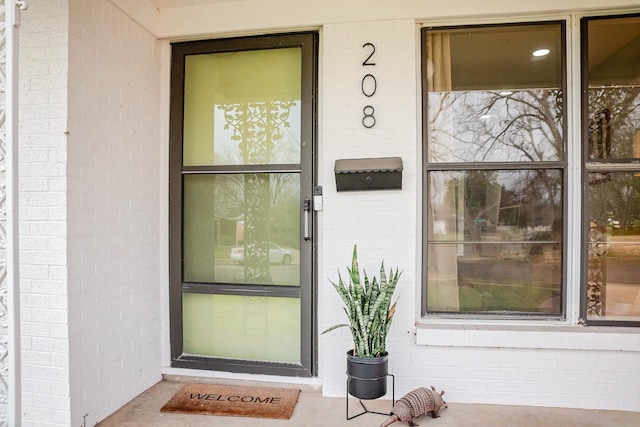 entrance to property with brick siding