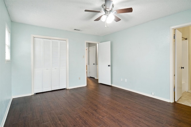 unfurnished bedroom with dark wood-type flooring, baseboards, and visible vents