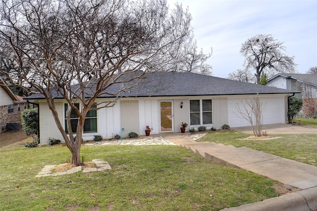 single story home with brick siding, a shingled roof, a front lawn, concrete driveway, and an attached garage