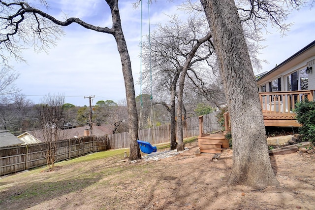 view of yard featuring a wooden deck and fence