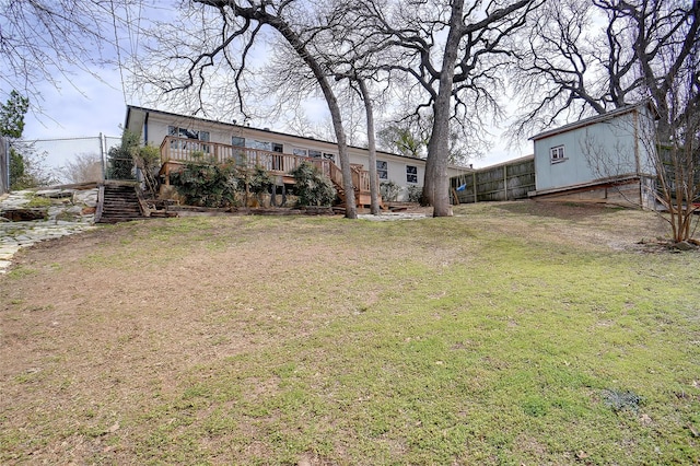 view of yard with stairway, a wooden deck, and fence