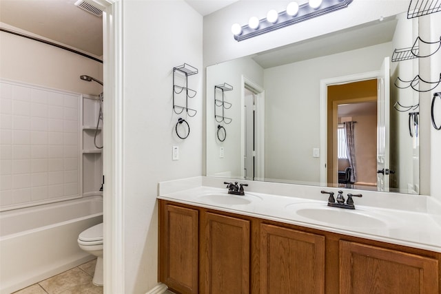 bathroom with tile patterned flooring, visible vents, double vanity, and a sink