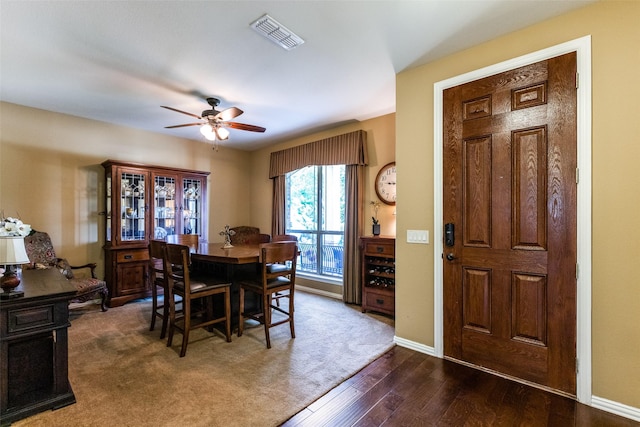 dining area with visible vents, baseboards, dark wood-type flooring, and ceiling fan